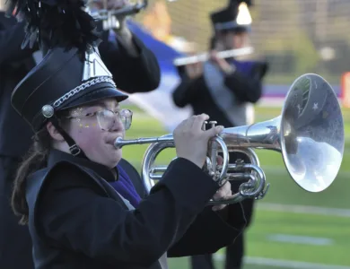 ‘A Nation in Motion:’ Marching Huskies bring bold red, white and blue flare to a milestone season